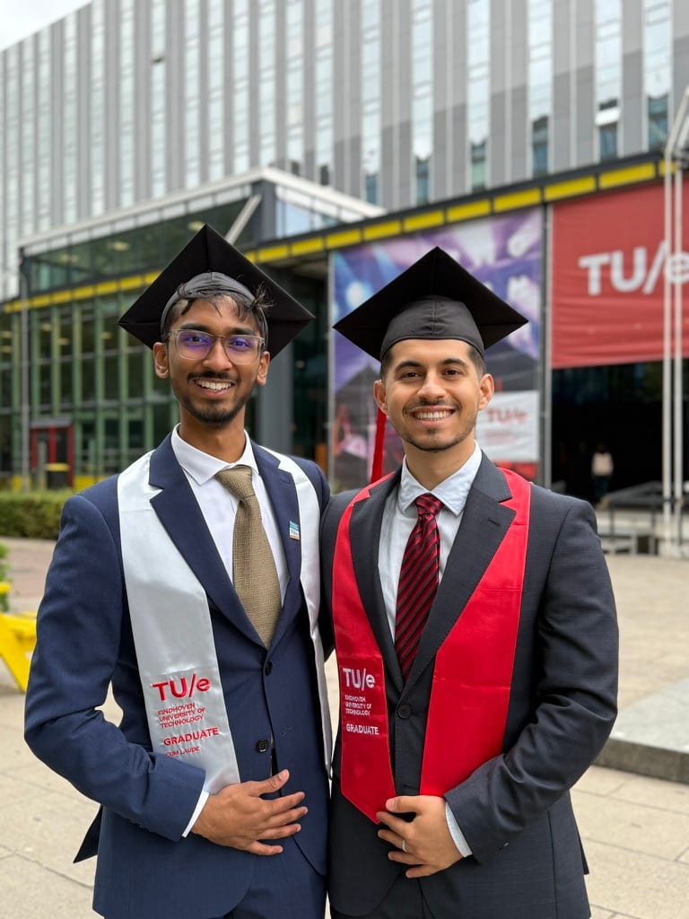 Mir and Bhuvan in graduation gowns at their TU/e graduation ceremony