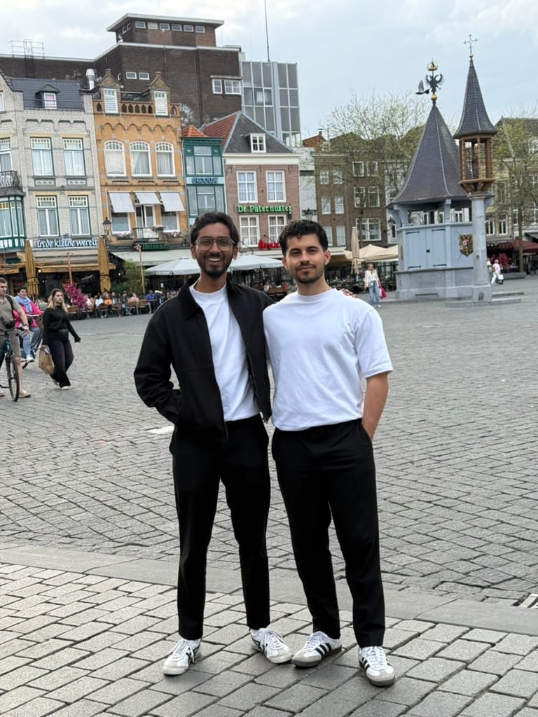 Mir and Bhuvan standing together in a city-centre square